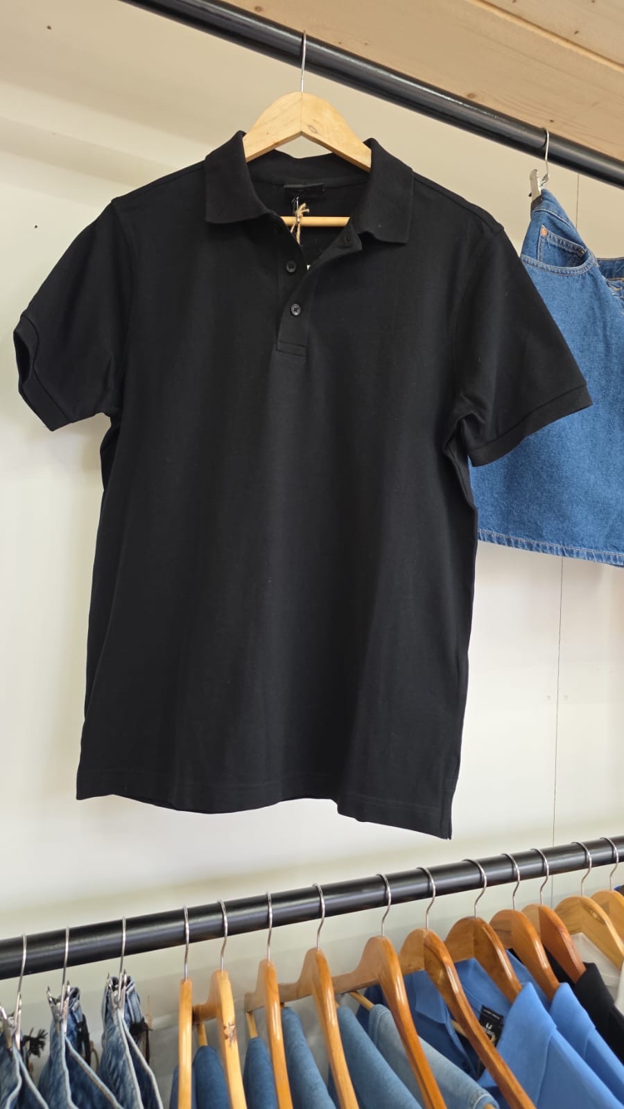 Tee Jays black polo shirt — sleek and versatile, front view