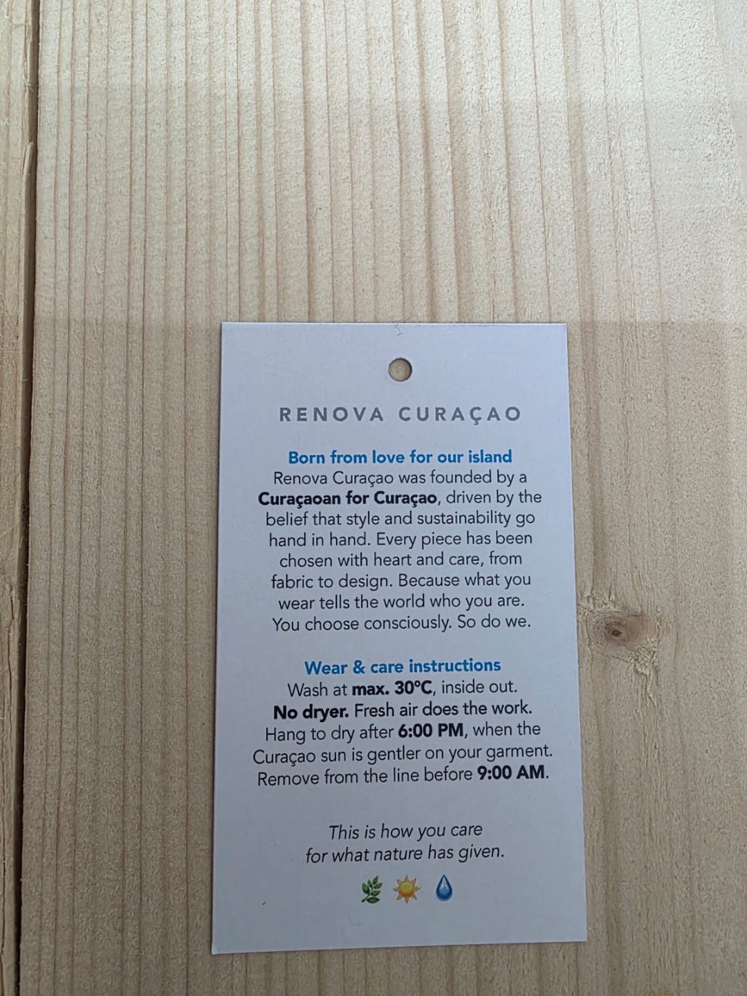 ReNova Curaçao care tag with sustainable garment care instructions